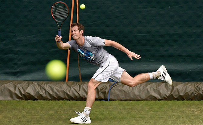 Andy Murray of Britain hits a return during a training session 