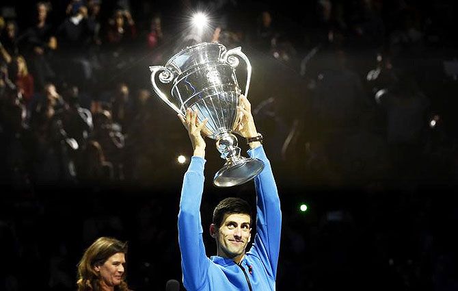 Serbia's Novak Djokovic holds aloft the trophy for finishing Number One ATP Men's Tennis Player in the World for 2015 following his win against Kei Nishikori at the ATP World Tour Finals at O2 Arena in London on Sunday