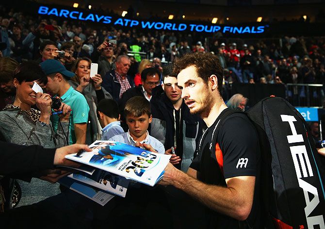 Great Britain's Andy Murray signs autographs after his men's singles match against Spain's David Ferrer on Monday