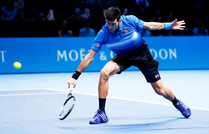 Novak Djokovic plays a backhand in his men's singles match against Roger Federer