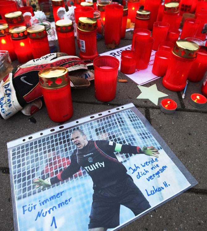 A hand-scrawled note that reads: 'I will never forget you. Forever Number 1' on a pictuire of deceased Hannover 96 goalie Robert Enke lies among a sea of candles before a memorial service prior to Enke's funeral at AWD Arena on November 15, 2009 in Hanover
