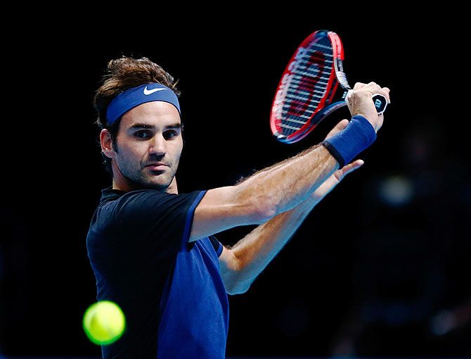 Switzerland's Roger Federer plays a backhand in his men's singles match against Serbia's Novak Djokovic on Day 3 of the Barclays ATP World Tour Finals at the O2 Arena in London on Tuesday