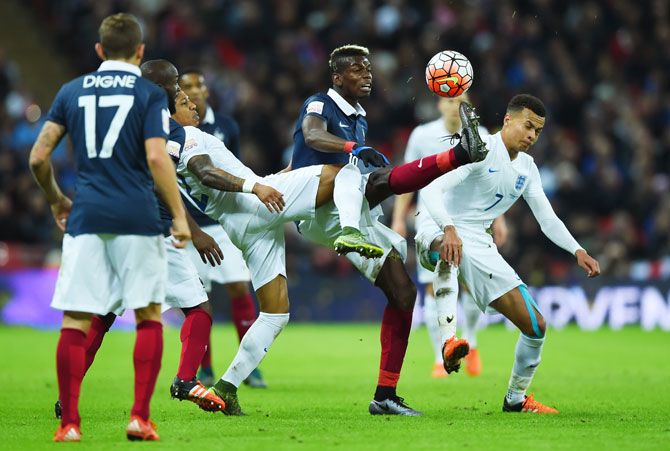 France's Paul Pogba (2nd from right) vies with England's Dele Alli (1st from right) and Nathaniel Clyne (3rd from right)