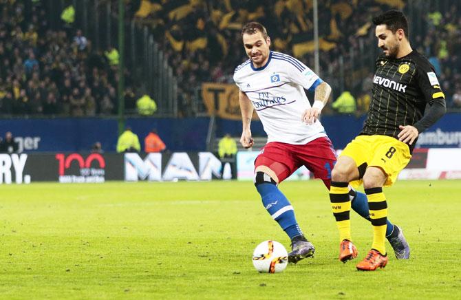 Hamburg SV's Pierre Michel Lasogga (left) and Dortmund's Ilkay Guendogan compete for the ball during their Bundesliga match at Volksparkstadion in Hamburg on Friday