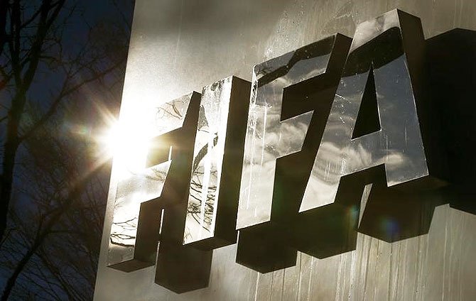 The sun is reflected in FIFA's logo in front of FIFA's headquarters in Zurich