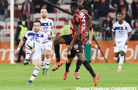 An Olympic Lyon player is challenged by a Nice player during their Ligue 1 match on Friday