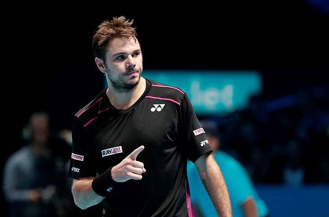 Switzerland's Stanislas Wawrinka celebrates during his match against Great Britain's Andy Murray in their round-robin match at the 02 Arena in London on Friday
