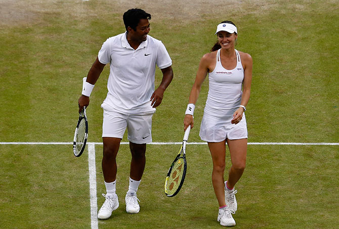 Leander Paes of India and Martina Hingis of Switzerland celebrate after winning the mixed doubles final at Wimbledon 