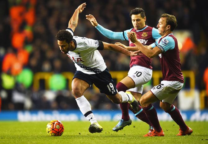 Tottenham Hotspur's Mousa Dembele goes past West Ham United's Mauro Zarate and Mark Noble