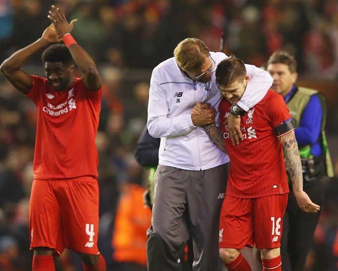Jurgen Klopp manager of Liverpool embraces Alberto Moreno 