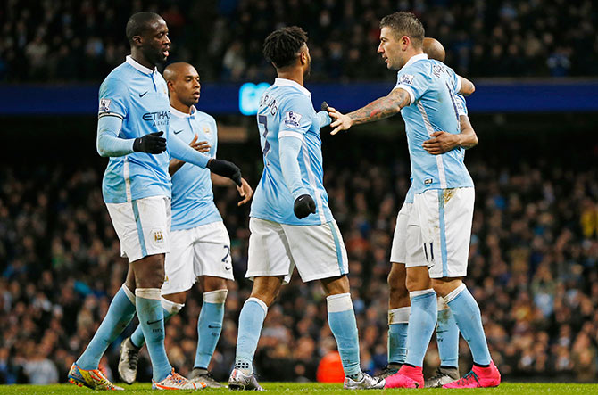 Aleksandar Kolarov celebrates with team mates after scoring third goal for Manchester City 