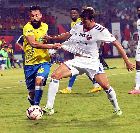 Players from Kerala Blasters FC and FC Goa vie for possession during the Indian Super League Match at Jawaharlal Nehru Stadium in Kochi on Sunday