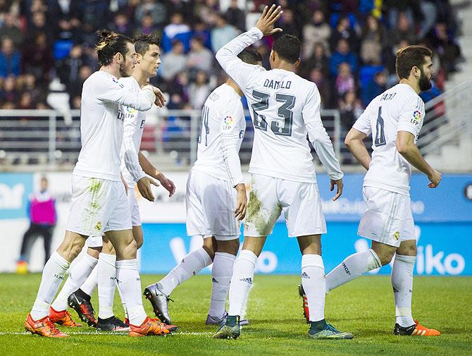 Real Madrid's Cristiano Ronaldo (2ndL) celebrates with teammates after scoring his team's second goal against Eibar during their La Liga match at Ipurua Municipal Stadium in Eibar on Sunday