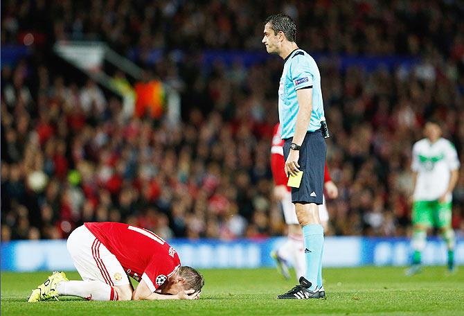 Manchester United's Bastian Schweinsteiger reacts as referee Viktor Kassai prepares to shows him a yellow card