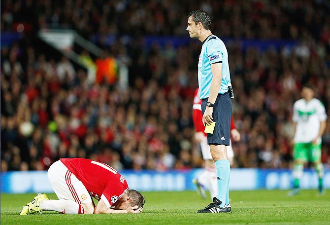 Manchester United's Bastian Schweinsteiger reacts as referee Viktor Kassai prepares to shows him a yellow card