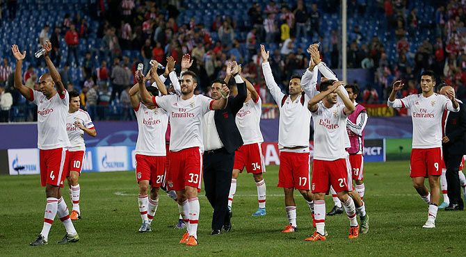 Benfica's players celebrate victory over Atletico Madrid at the end of their Champions League group C match at Vicente Calderon stadium in Madrid, on Wednesday