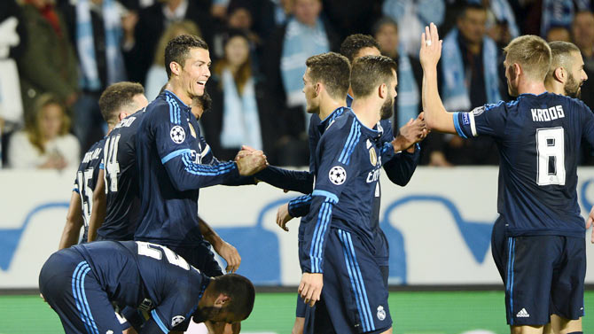 Real Madrid's Cristiano Ronaldo (left) celebrates with teammates after scoring the opening goal against Malmo FF during their Champions League group A match at Malmo New Stadium in Malmo, Sweden on Wednesday