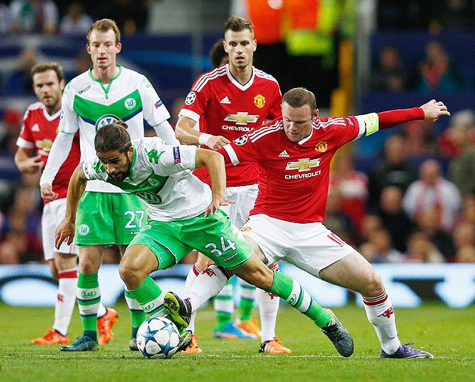 VfL Wolfsburg's Ricardo Rodriguez evades Manchester United Wayne Rooney as they vie for possession