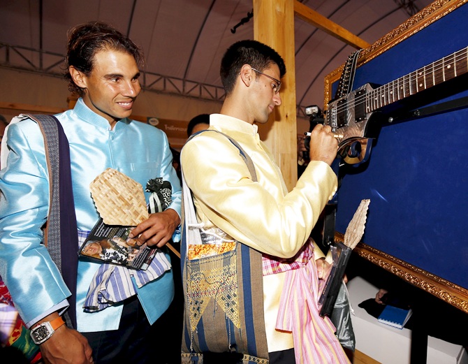 Rafael Nadal, left,  of Spain looks on