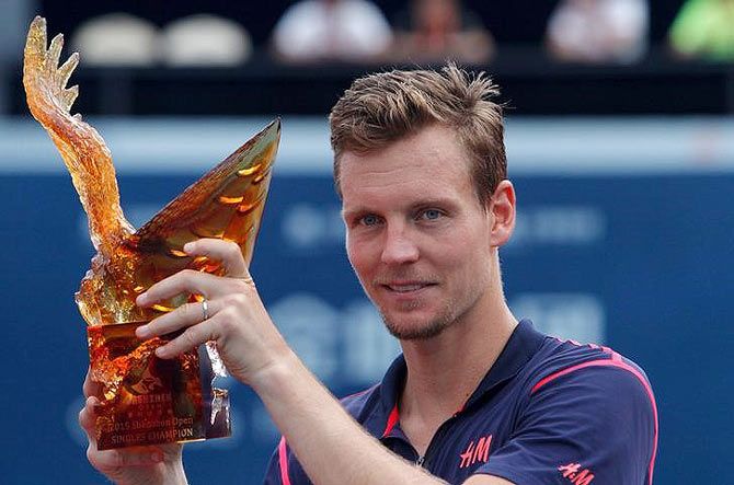 Tomas Berdych of the Czech Republic celebrates winning in final match of Shenzhen open tennis tournament against Spain's Guillermo Garcia-Lopez, in Guangdong province, on Monday