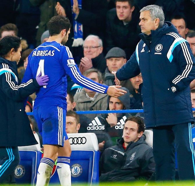 Cesc Fabregas of Chelsea high fives Jose Mourinho manager of Chelsea as he is replaced