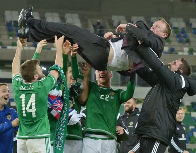 Virat Kohli Northern Ireland manager Michael O'Neill is thrown in to the air