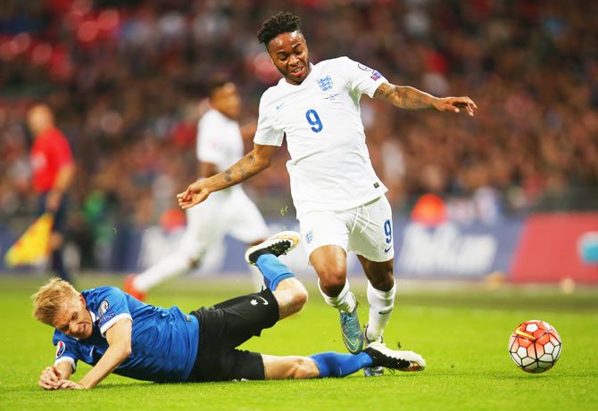 England's Raheem Sterling holds of Estonia's Taijo Teniste during the UEFA Euro 2016 Group E qualifying match at Wembley in London on Friday