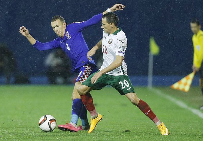 Croatia's Ivan Perisic challenges Bulgaria's Zhivko Milanov (right) during their Euro 2016 Group H qualifiER in Zagreb, Croatia on Saturday