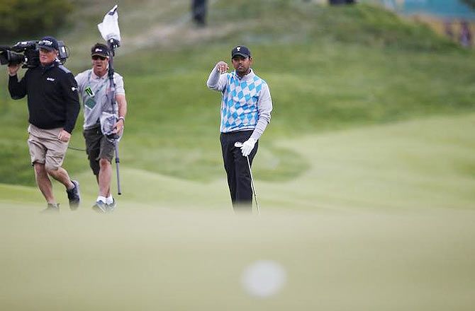 International team member Anirban Lahiri of India gestures after hitting a shot on the fifteenth green during the four ball matches of the 2015 Presidents Cup golf tournament in Incheon on Saturday