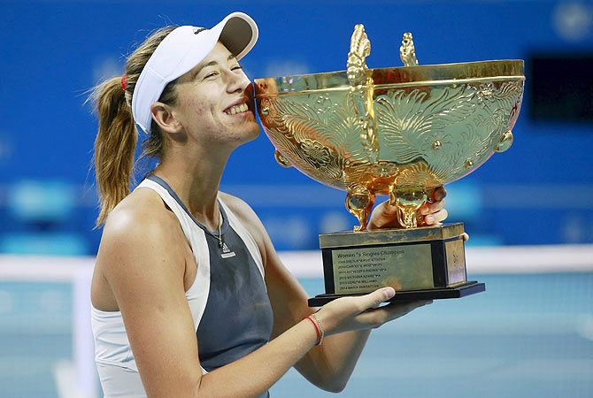 Spain's Garbine Muguruza poses with her trophy during the award ceremony after winning the China Open women's singles final against Switzerland's Timea Bacsinszky in Beijing on Sunday