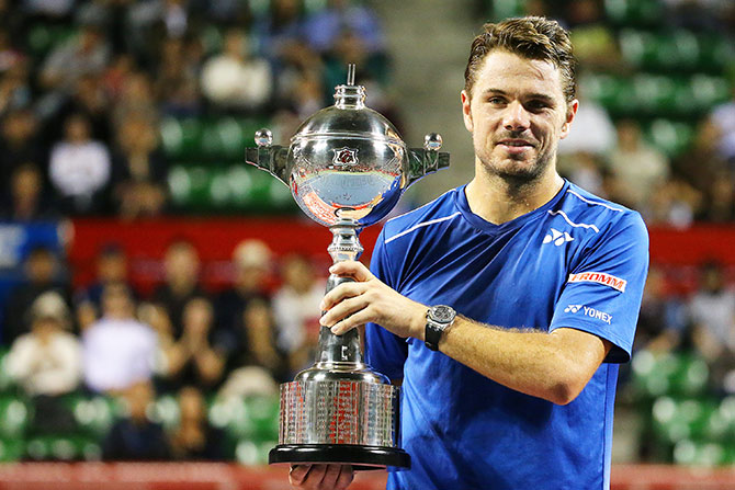 Stan Wawrinka of Switzerland celebrates with his trophy after winning the Japan Open 