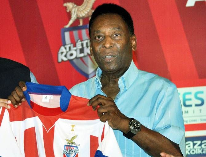 Football legend Pele displays the Atletico de Kolkata jersey that was presented to him
