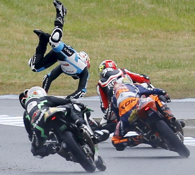 Honda Moto3 rider Livio Loi of Belgium falls during the Japanese Grand Prix at the Twin Ring Motegi circuit in Motegi, north of Tokyo on October 11