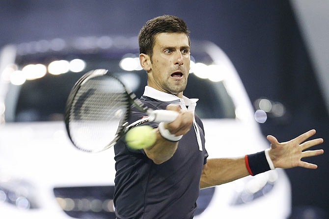 Serbia's Novak Djokovic returns a shot against Slovakia's Martin Klizan during their second round match of Shanghai Rolex Masters at Qi Zhong Tennis Centre in Shanghai on Wednesday