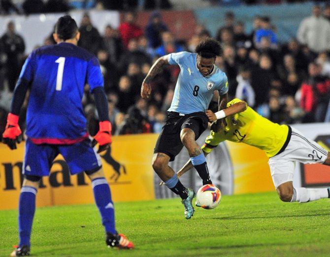 Uruguay's Abel Hernandez, centre, shoots to score