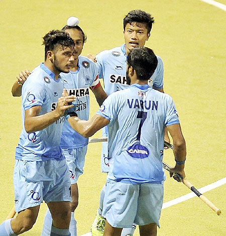 India players celebrate with Harmanpreet Singh after he scored against Malaysia on Thursday