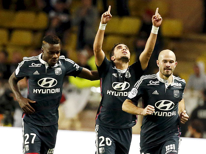 Lyon's Rafael Da Silva (centre) celebrates after scoring against Monaco during their French Ligue 1 match at Louis II stadium in Monaco, on Friday