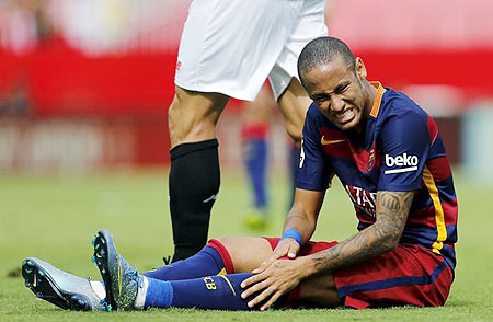 Barcelona's Neymar winces in pain