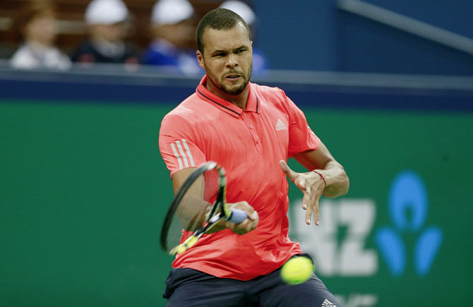 Jo-Wilfried Tsonga returns a shot against Novak Djokovic