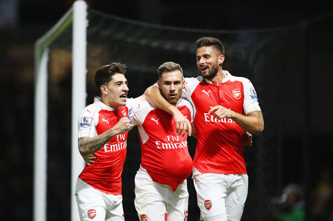 Arsenal's Aaron Ramsey (centre) celebrates with teammates Hector Bellerin (left) and Olivier Giroud (right)  after scoring