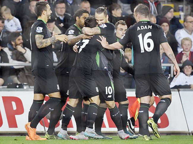 Stoke's Bojan Krkic celebrates with teammates after scoring from the penalty spot