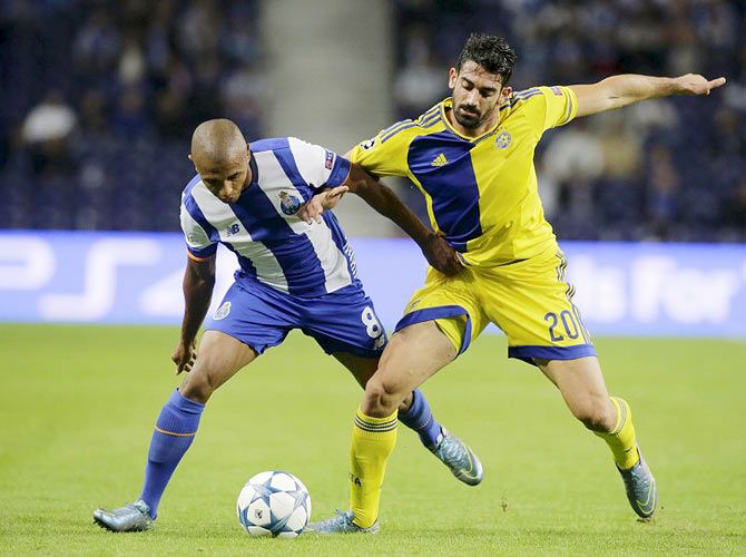Porto's Yacine Brahimi (left)) fights for the ball with Maccabi Tel Aviv's Ben Harush during their Champions League group G match at Dragao Stadium in Porto, on Tuesday