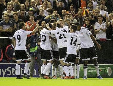 Valencia's players celebrate after they scored a goal against Gent during their Champions league Group H match at the Mestalla stadium in Valencia