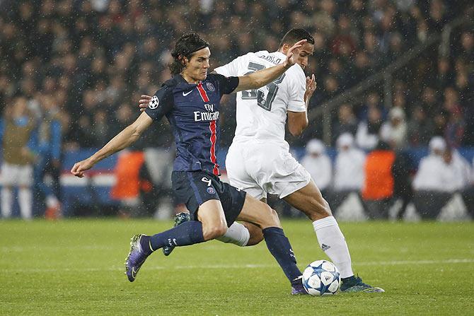 Paris Saint Germain's Edinson Cavani (left) challenges Real Madrid's Danilo during their Champions League Group A match at the Parc des Princes stadium in Paris, on Tuesday