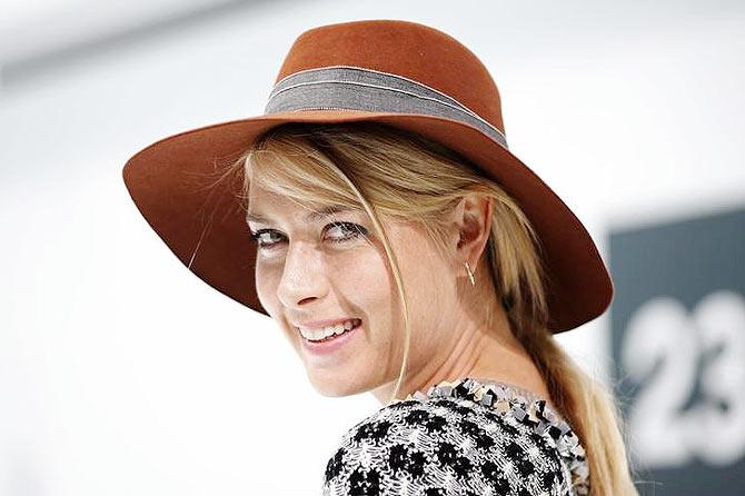 Russia's tennis player Maria Sharapova poses before the Spring/Summer 2016 women's ready-to-wear collection for fashion house Chanel at the Grand Palais which is transformed into a Chanel airport during the Fashion Week in Paris