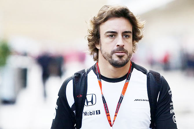 McLaren's Fernando Alonso arrives at the track for a practice session in Austin, Texas on Friday