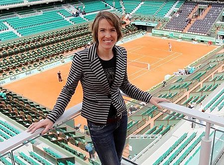 Former Belgian tennis player Justine Henin poses on top roof of the Philippe Chartrier court at the Roland Garros stadium in Paris