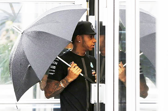 Mercedes' Lewis Hamilton arrives at the track for a practice session 