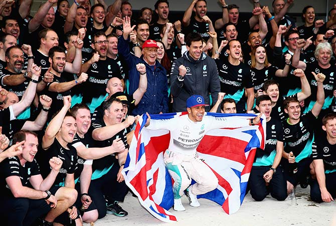 Lewis Hamilton of Great Britain and Mercedes GP celebrates with the team