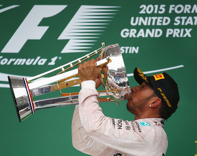 Lewis Hamilton of Great Britain and Mercedes GP celebrates on the podium after winning the United States Formula One Grand Prix and win the 2015 F1 Championship